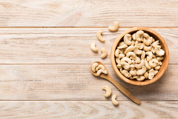 cashew nuts in wooden bowl on table background. top view. Space for text Healthy food