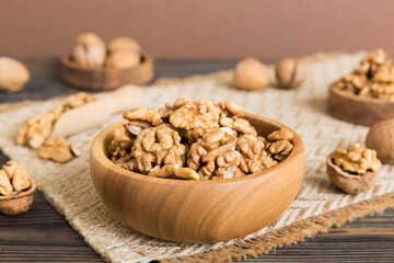 Fresh healthy walnuts in bowl on colored table background. Top view Healthy eating bertholletia concept. Super foods
