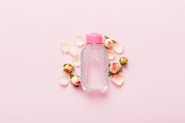 Fancy healthcare bottles for serum, micellar, tonic, toner, lotion, water and cream with rose flower. Natural oranic spa cosmetics concept. Mockup, template, Top view