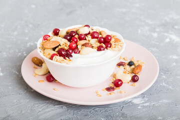 Healthy breakfast food with granola, yogurt, fruits and nuts. Dessert parfait with dried fruits for breakfast