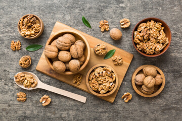 Obraz na płótnie Canvas Walnut kernel halves, in a wooden bowl. Close-up, from above on colored background. Healthy eating Walnut concept. Super foods with copy space