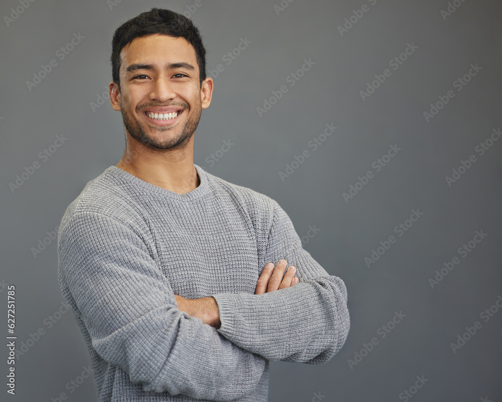 Sticker Portrait of happy man in studio with mockup, arms crossed and smile on studio backdrop in casual fashion. Relax, confidence and face of male on grey background with happiness and pride with space.