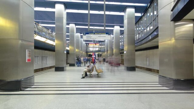Interior of a modern subway station with trains timelapse hyperlapse. People waiting on a platform