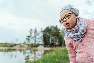 Portrait of focused cute funny girl at nature. Empty space for text.