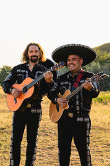 Mexican musicians mariachi play guitars