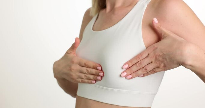 Woman hands touch chest and problem areas. Breast cancer self diagnosis and healthcare and medical concept