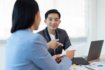 Asian business meeting to analyze the on the financial report in the meeting room