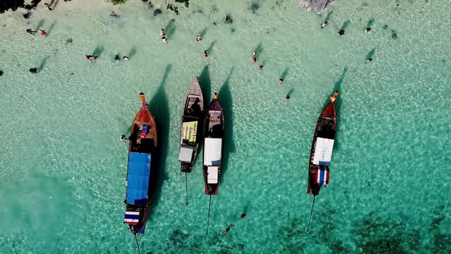 PHI PHI DON, THAILAND - DECEMBER 24, 2019: Aerial view of long tail boats and tourists visting Monkey Beach