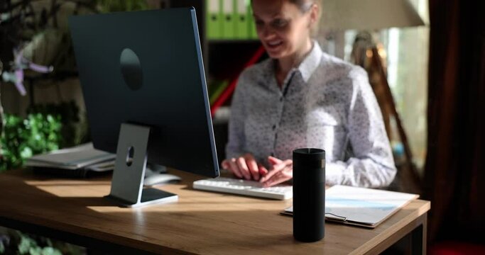 Humidifier device on office computer desk. Manager or freelancer using an essential oil diffuser sitting at desk