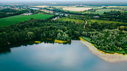 Aerial drone view of lake among forest, Nordrhein westfalen, Germany in summer day. 