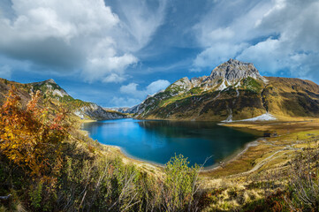 Fototapeta na wymiar Autumn alpine Tappenkarsee lake and rocky mountains above, Kleinarl, Land Salzburg, Austria. Picturesque hiking, seasonal, and nature beauty concept scene.