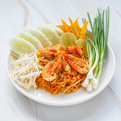 Pad Thai, Pud Thai stir fried noodle with shrimp served with mung bean sprout, cucumber, lime, chilli and spring onion, Thai famous street food, popular street food in Thailand