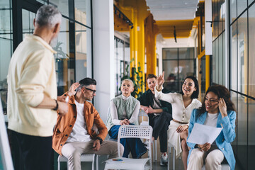 Cheerful colleagues discussing project in office