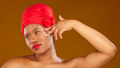 Woman, face touch and hair scarf with natural beauty, makeup and haircare in studio. Brown background, African female person and cosmetics of a model with head wrap for culture with skincare glow