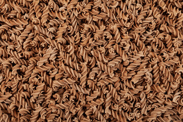 Uncooked Pasta di Lino, close-up. Flaxseed gluten free pasta is rich in fiber, iron, B vitamins and...