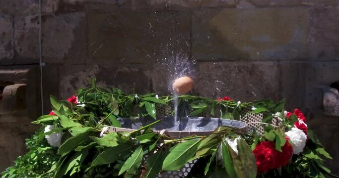Egg balanced in the  jet of a water fountain.Catalonia tradition. The dancing egg or The egg how dances (L'ou com balla in Catalan) is an old tradition that takes place in several towns in Catalonia,