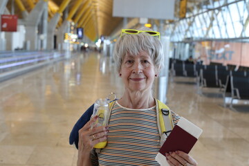 Seventy yeears old woman walking around  an airport terminal 