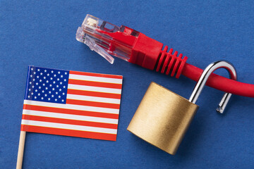 Open lock on a network wire and a flag on a colored background, a concept on the theme of...
