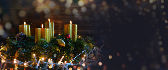 Christmas background with four burning advent candles on fir tree wreath - banner, header, panorama...