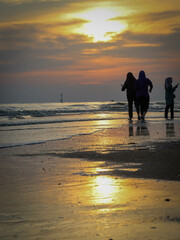 silhouette of people at the beach during sunset