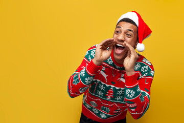 african american guy in new year clothes and santa hat screams and speaks on yellow isolated background