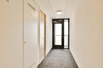 an empty hallway with no people on the other side, and there's a door leading to another room