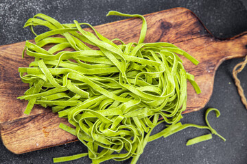 green tagliatelle raw pasta basil second course vegetable food healthy meal food snack on the table...