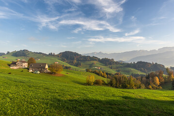 Fototapeta na wymiar Hilly mountain landscape with meadows and farm houses in the Appenzell Alps in autumn, Appenzellerland, Canton Appenzell Innerrhoden, Switzerland