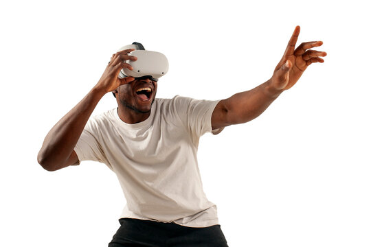 african american man in white t-shirt plays video games in virtual reality glasses and touches with his hand