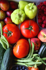 Wooden crate full of healthy colorful seasonal fruit and vegetable. Top view.