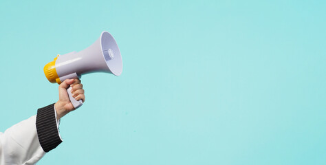 Hand is hold megaphone and wear chef uniform on green or mint or Tiffany Blue background.