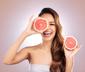 Vitamin c, grapefruit and portrait of woman with healthy, natural or organic beauty isolated in a brown studio background. Excited, happy and young female person with citrus for skincare or detox