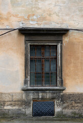 Fototapeta na wymiar Old window on the wall of a building