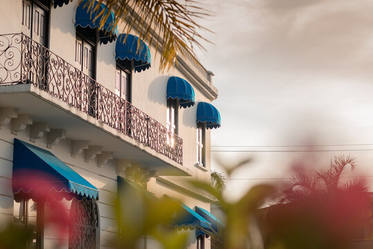 Facade of gobernacion or municipal house of Bocas Del Toro in Panama on a sunny day. visible sun reflecton and some flowers.