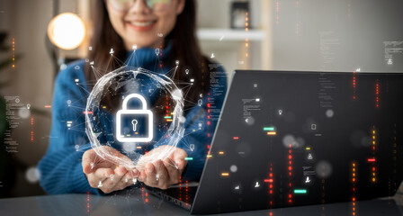 Cybersecurity technology concept. A person is using a computer with data privacy protection from digital threats. Protect system hardware, software and applications Connect to work on the Internet. - obrazy, fototapety, plakaty