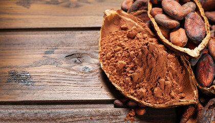 Cocoa powder and cocoa beans on wooden background