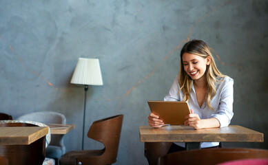 Beautiful success woman working, using digital tablet. Business, freelancer, social media concept.