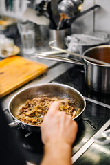 Chef cook hand cooking food at the restaurant kitchen