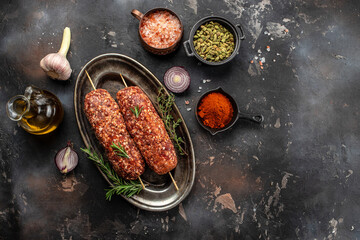 raw Lula kebab on skewers with spices, on a wooden background, Concept healthy and balanced eating....