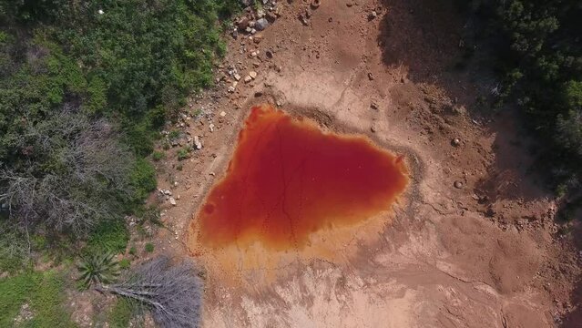 Drone footage of a red lake in Elba Island, Tuscany, Italy
