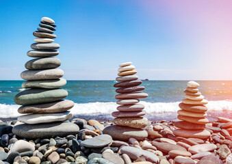 Three pyramids of stones for meditation lying on seacoast - 627305348