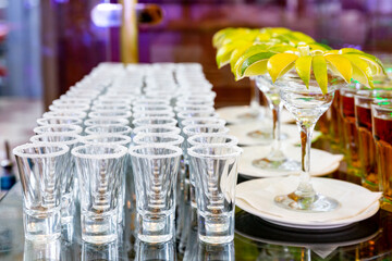 Buffet table with lime on a plate and shot glasses with salt. Serving on a holiday at an event - 627305360