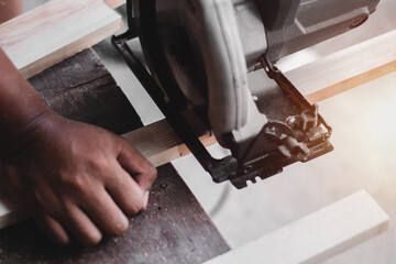 Carpenter working with equipment on wooden table, And measurement of a wooden plank