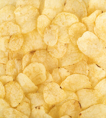 Background of crispy natural potato chips. Photography of food and drinks.