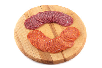 Sliced Italian salami and pepperoni on a wooden cutting board. - obrazy, fototapety, plakaty