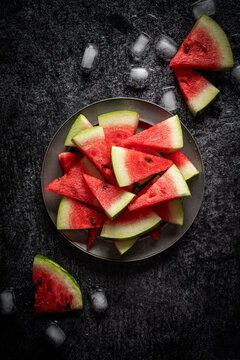Slices of watermelon on dark surfagee.