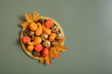 Golden frame with pumkins, roses and maple leaves. Autumn minimalist aesthetic concept