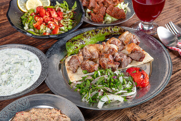 Turkish cuisine Meat skewers. Barbecue skewers with juicy meat on metal plate. Shish kebab barbecue...