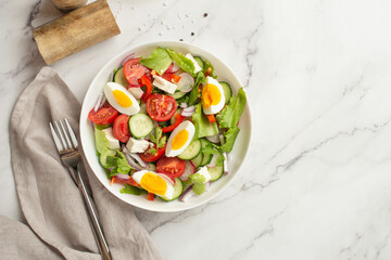 salad of fresh vegetables and greens with egg and feta cheese