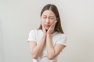 Face expression suffering from sensitive teeth and cold, asian young woman, girl feeling hurt, pain touching cheek, mouth with hand. Toothache molar tooth, dental problem isolated on white background.